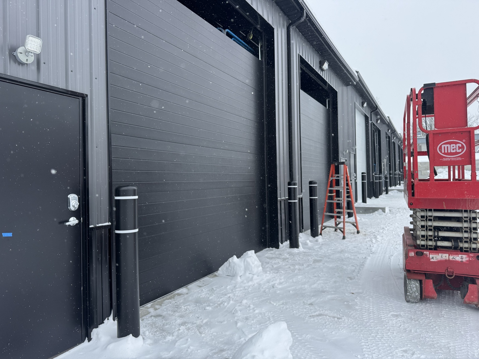 Insulated overhead garage doors during final construction of PROFLEX in Akron Ohio